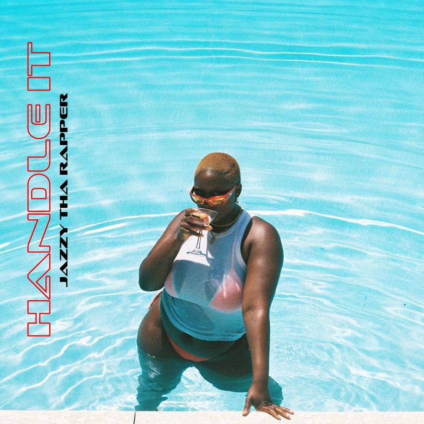 Person in a swimming pool holding a glass, wearing sunglasses and a swimsuit, with water in the background.