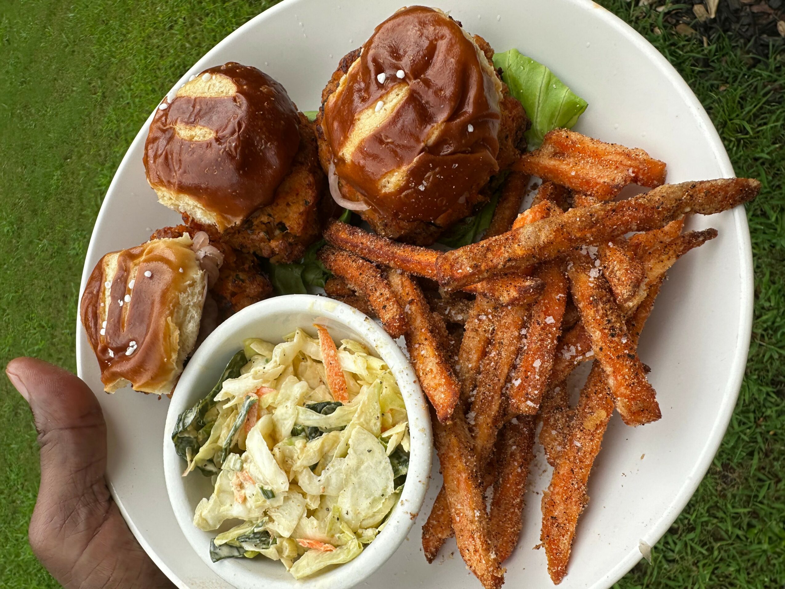 Plate with meatloaf, fried sweet potato fries, and a side salad with lettuce and vegetables, on a white dish.
