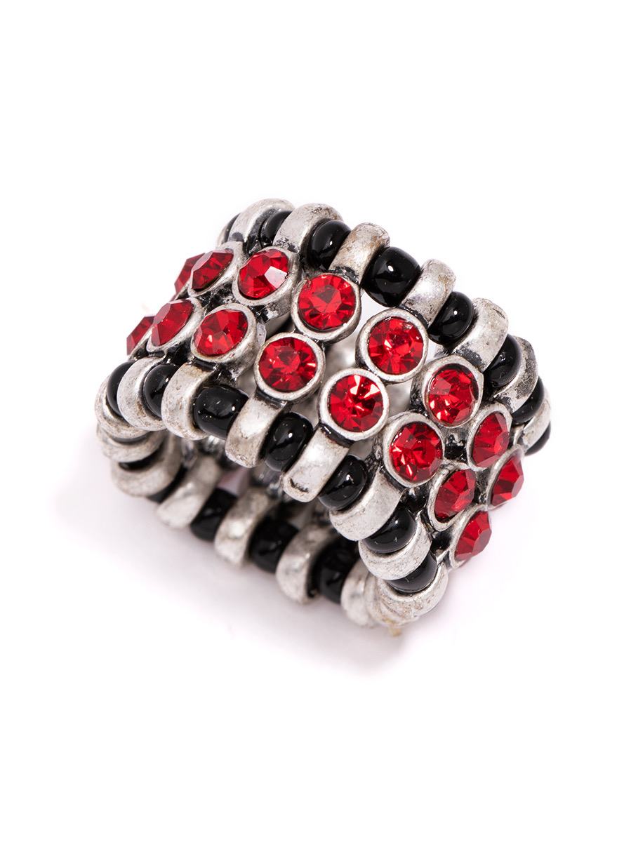 Ring with multiple rows of red and black gemstones set in silver metal, arranged in a band shape.