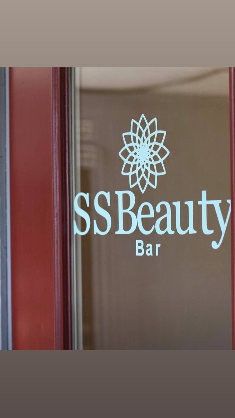 Glass door with a logo and text reading 'SSBeauty Bar' and a flower design.