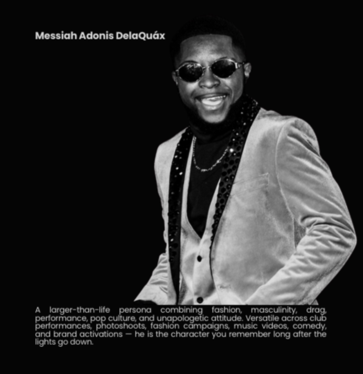 Young man wearing sunglasses, a blazer, and a chain, smiling against a black background. Text overlays the top left corner.