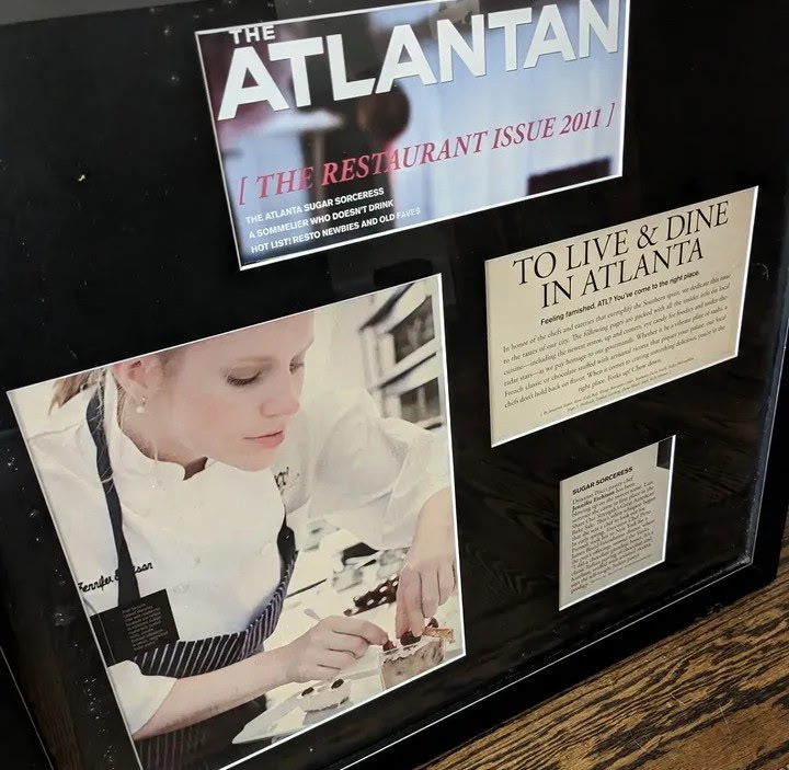 Display case with magazine cover, a woman cooking, and text about dining in Atlanta.