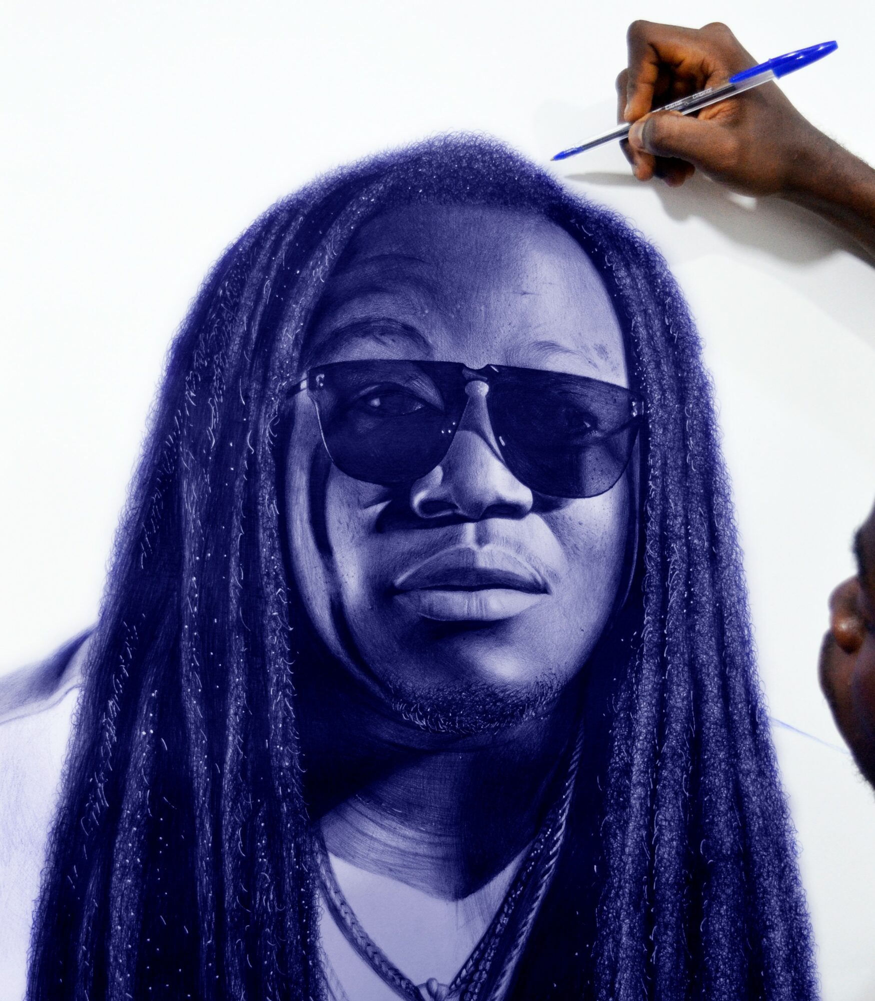 Person with long dreadlocks wearing sunglasses, being drawn on with a pen, white background