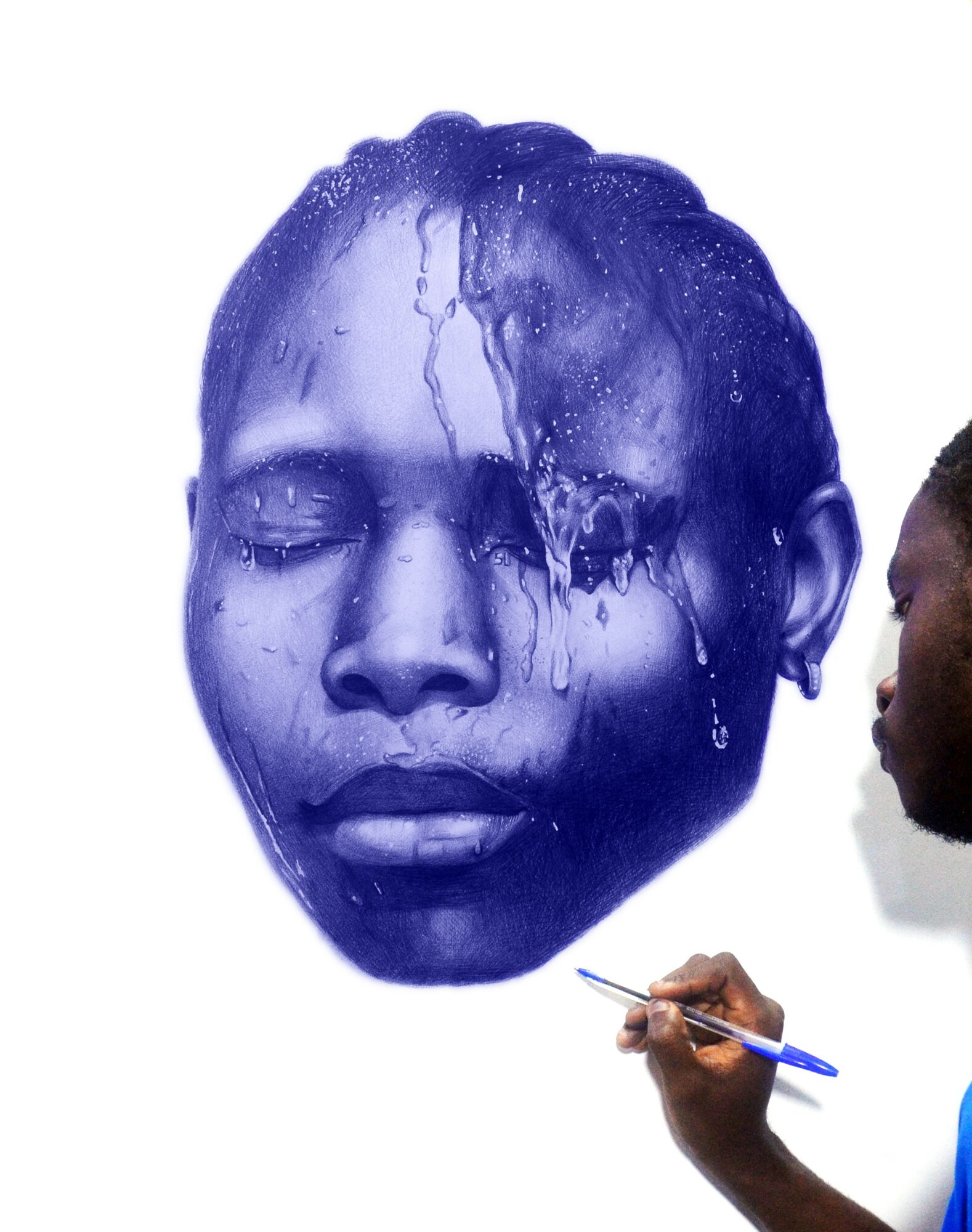 Artist painting a large blue portrait of a person's face with closed eyes and water effects, on a white background.