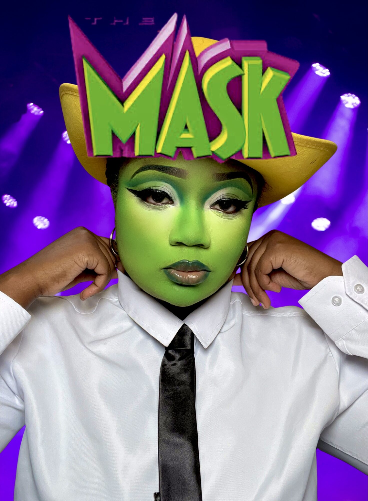Person with green face makeup wearing a yellow hat and a white shirt, with a colorful 'MASK' sign above their head.