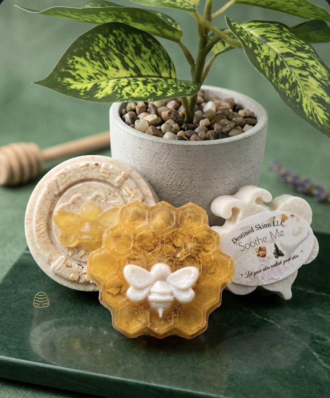 A potted plant with green and yellow leaves, honey soap, and a soap dish on a green surface.