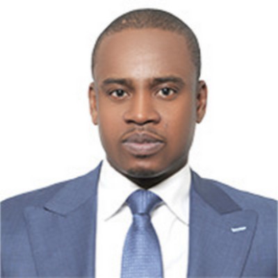 Portrait of a man in a blue suit and tie, facing forward, with a neutral expression.