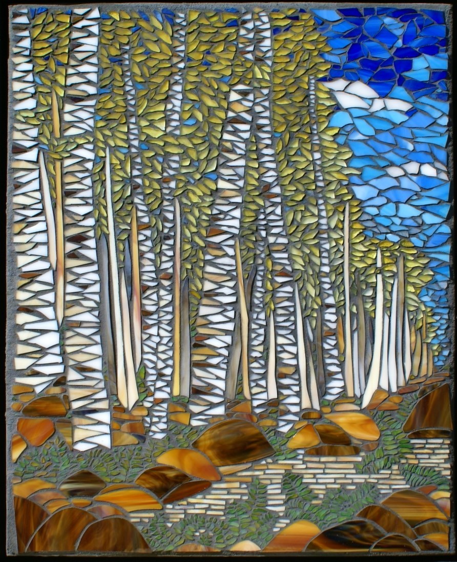 Mosaic artwork depicting tall trees with green leaves, a blue sky with clouds, and a ground with rocks and plants.